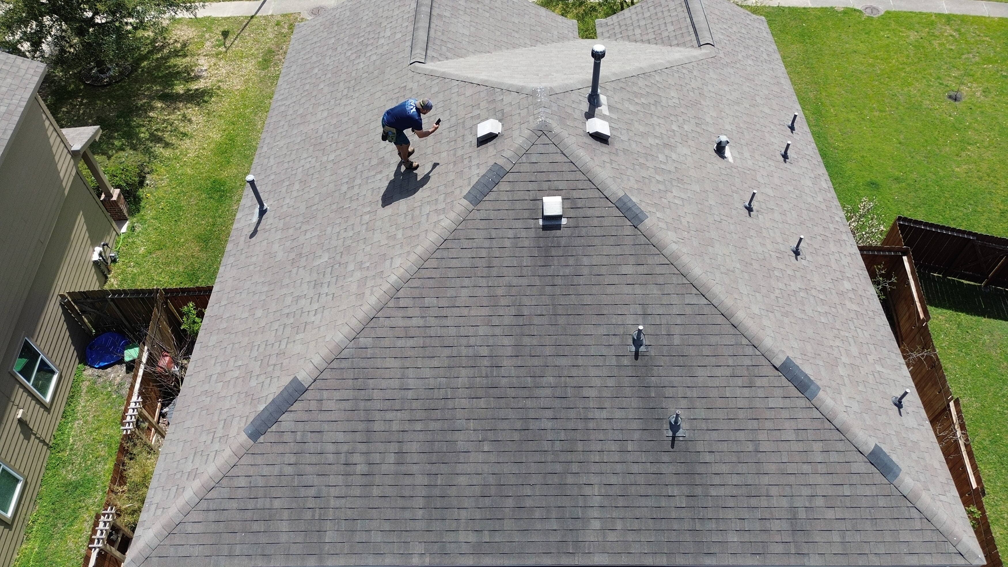 Inspector documenting roof damage during a drone-assisted inspection